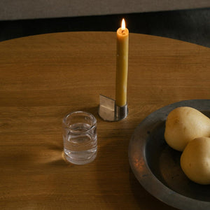 FUNDAMENT CANDLE HOLDER | STAINLESS STEEL | FORM 1 on wooden table with fruits bowl