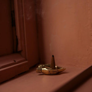 incense cones with brass holder by doing goods on brick colour interior