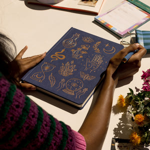 JUMBO JOURNAL | MYSTIC ICONS being written on a desk