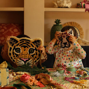 cloudy tiger wool rug by doing goods held by children inside the house