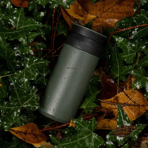 kinto travel tumbler in khaki on green tree leaves