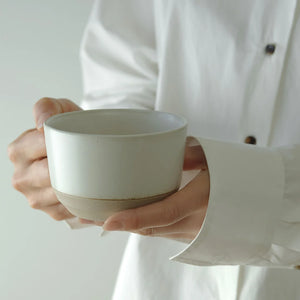 kinto tea mug being held by hands