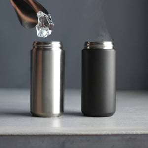 kinto travel tumbler in black next to stainless steel