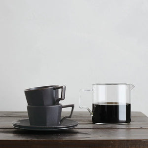 oct coffee cup in black by kinto styling on table with coffee jar