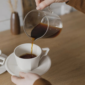 coffee poured into oct coffee cup in white by kinto