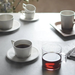 oct coffee cup in white by kinto on breakfast table with coffee jar