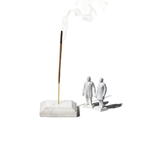 square white marble incense holder with little figurine next to it