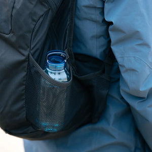 water bottle in blue by kinto carried in a backpack