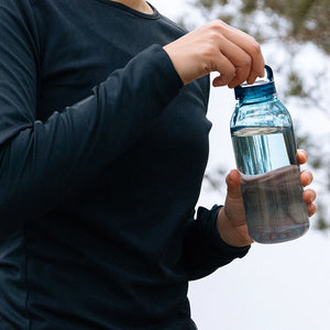 woman held water bottle in blue by kinto