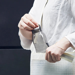 woman put water bottle into bag