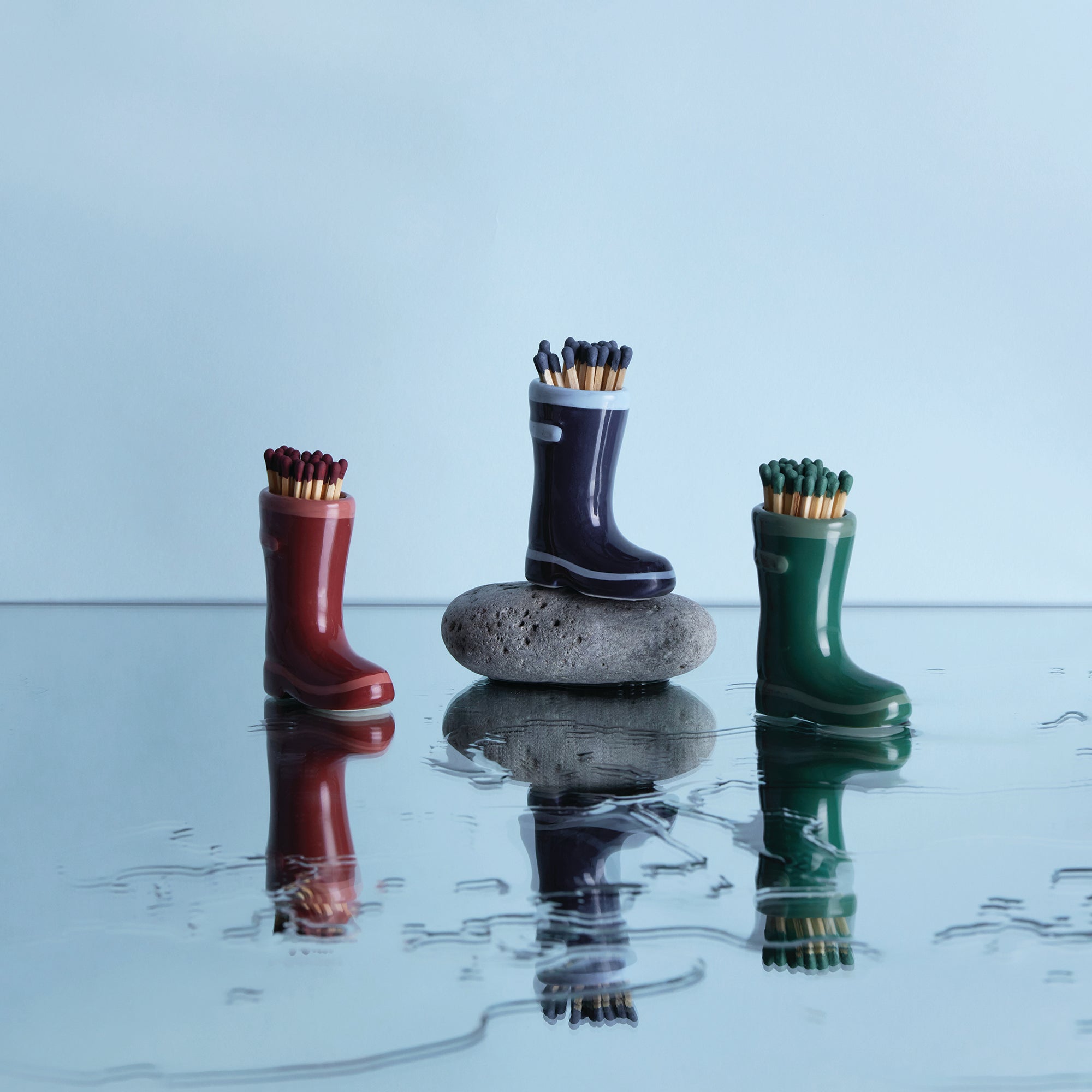 red ceramic wellington boots holding matches